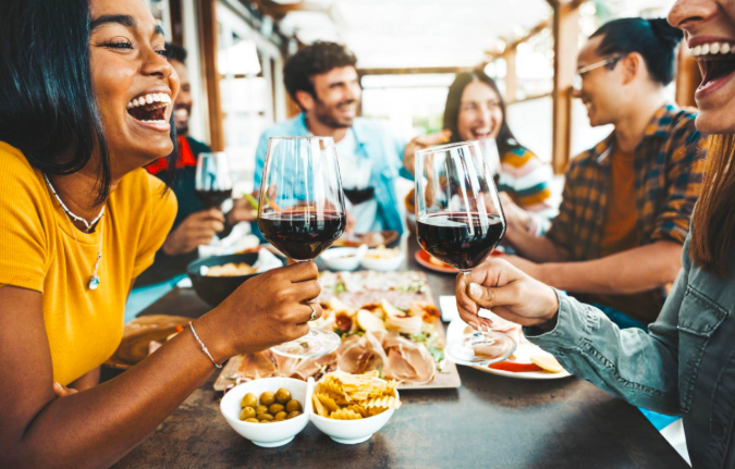 Group of friends toasting with wine at a restaurant