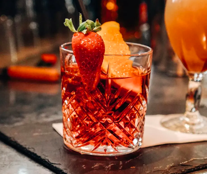 Refreshing cocktail with strawberry garnish