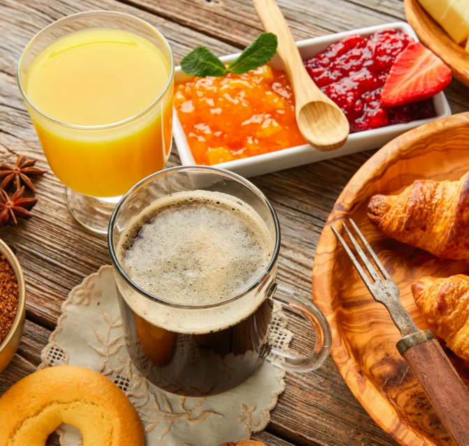 Breakfast spread with coffee, juice, and pastries